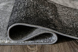 Brycebourne rug rolled showing jute backing and pile height