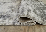 Rolled detail of Gerdie cream and gray area rug