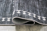 Rolled detail of Arloman black cream gray 5x7 rug