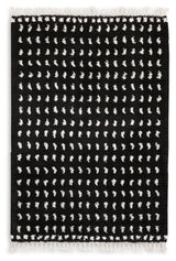 Close-up of Minston black and white woven dot pattern rug