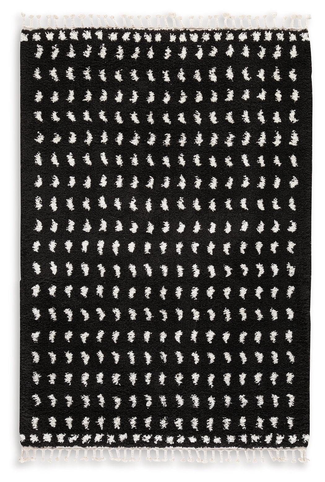 Close-up of Minston black and white woven dot pattern rug