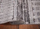 Rolled Henchester multi 5' x 7' rug showcasing fabric backing
