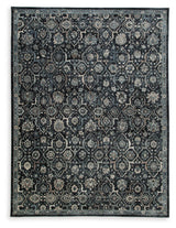 Hilcott close-up of floral pattern on blue cream brown rug