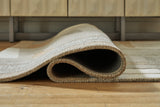 Rolled detail of Abbotton taupe gray caramel rug
