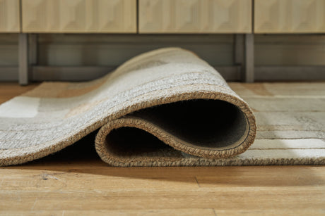 Rolled Abbotton rug showing pile and backing