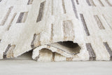 Rolled side view of Leesdale ivory brown black striped rug