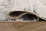 Rolled Gentor rug showing blue and ivory colors