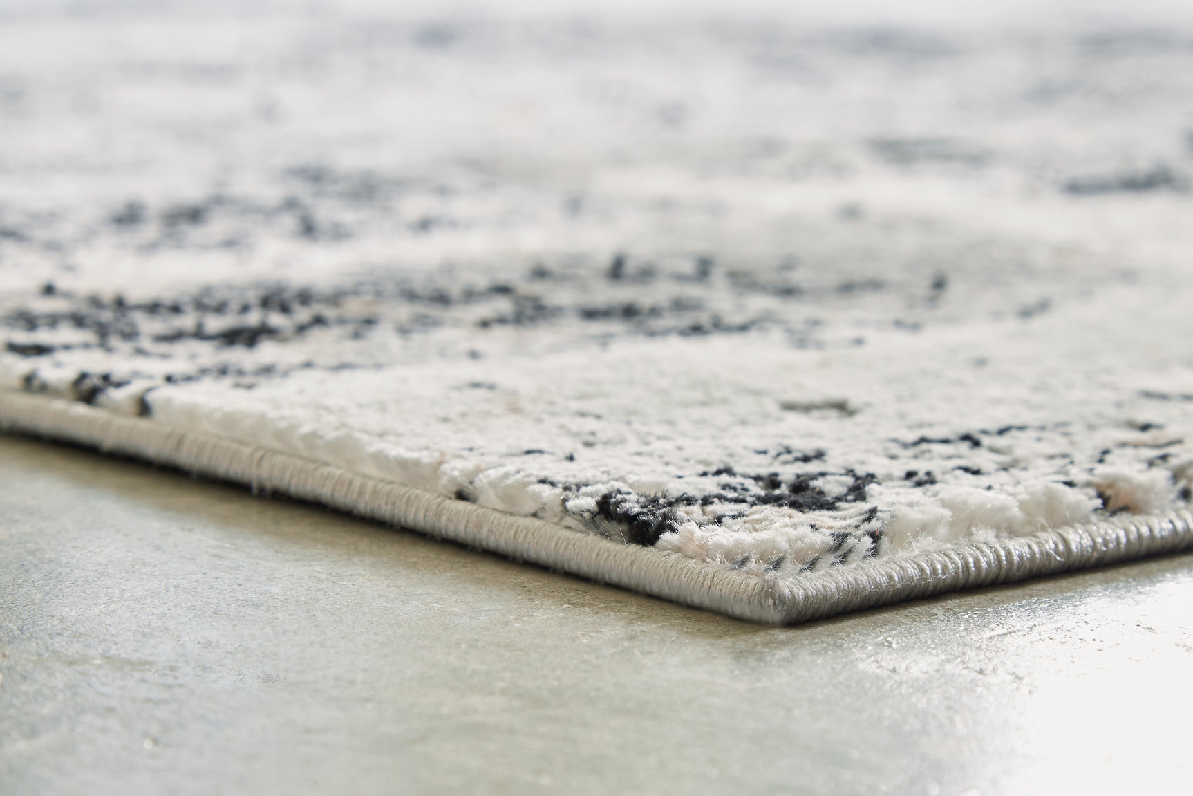 Rolled detail of Langwell Extra Large Rug showcasing pile and fabric
