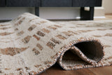 Fabric swatch showing polyester material and color shades of Brettler rug