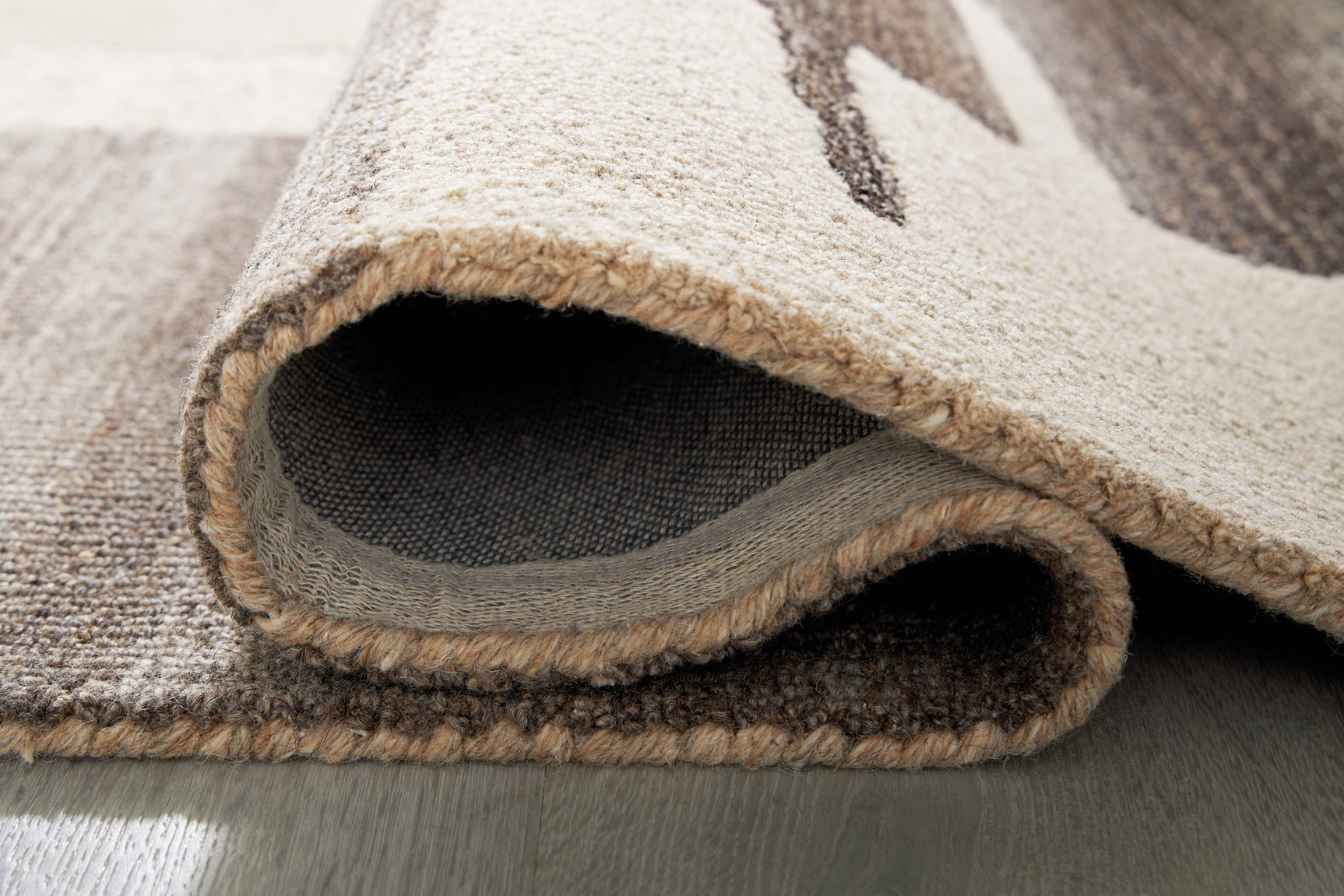 Rolled Kencher Beige Brown Rug showing thickness