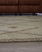 Rolled Guyford wool rug showing thickness and cotton backing