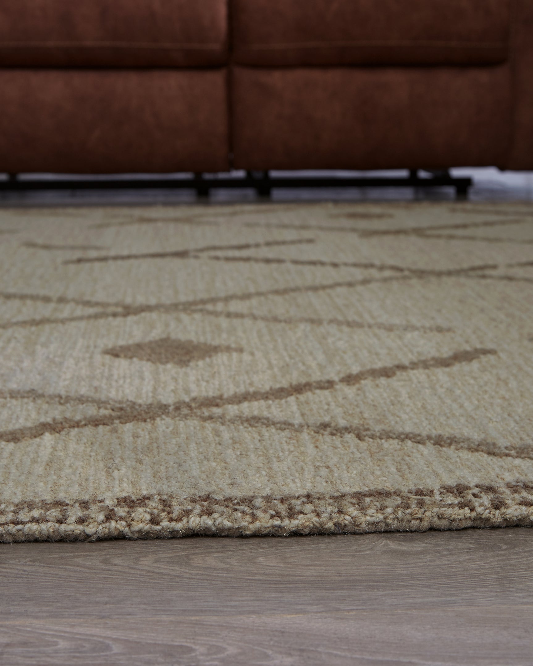 Rolled Guyford wool rug showing thickness and cotton backing
