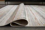 Rolled view of Artney Multi Large Rug showing pattern and texture