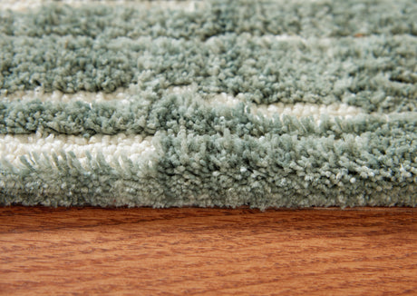 Close-up of the teal and white abstract striped pattern on the Cayworth rug