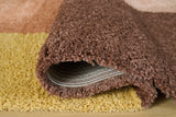 Rolled view of Gailmore cream pink ocher rug