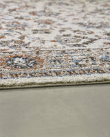 Edge detail of Beritham Medium Blue/Brown/Beige Rug rolled up