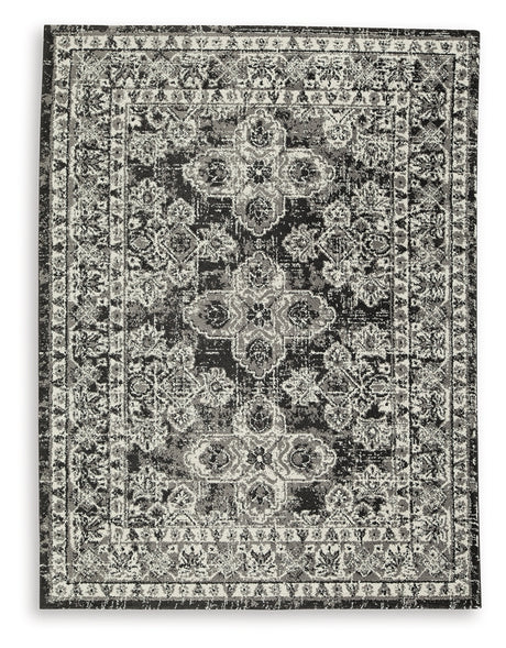 Close-up detail of Glennisman Medium Rug weave and botanical design