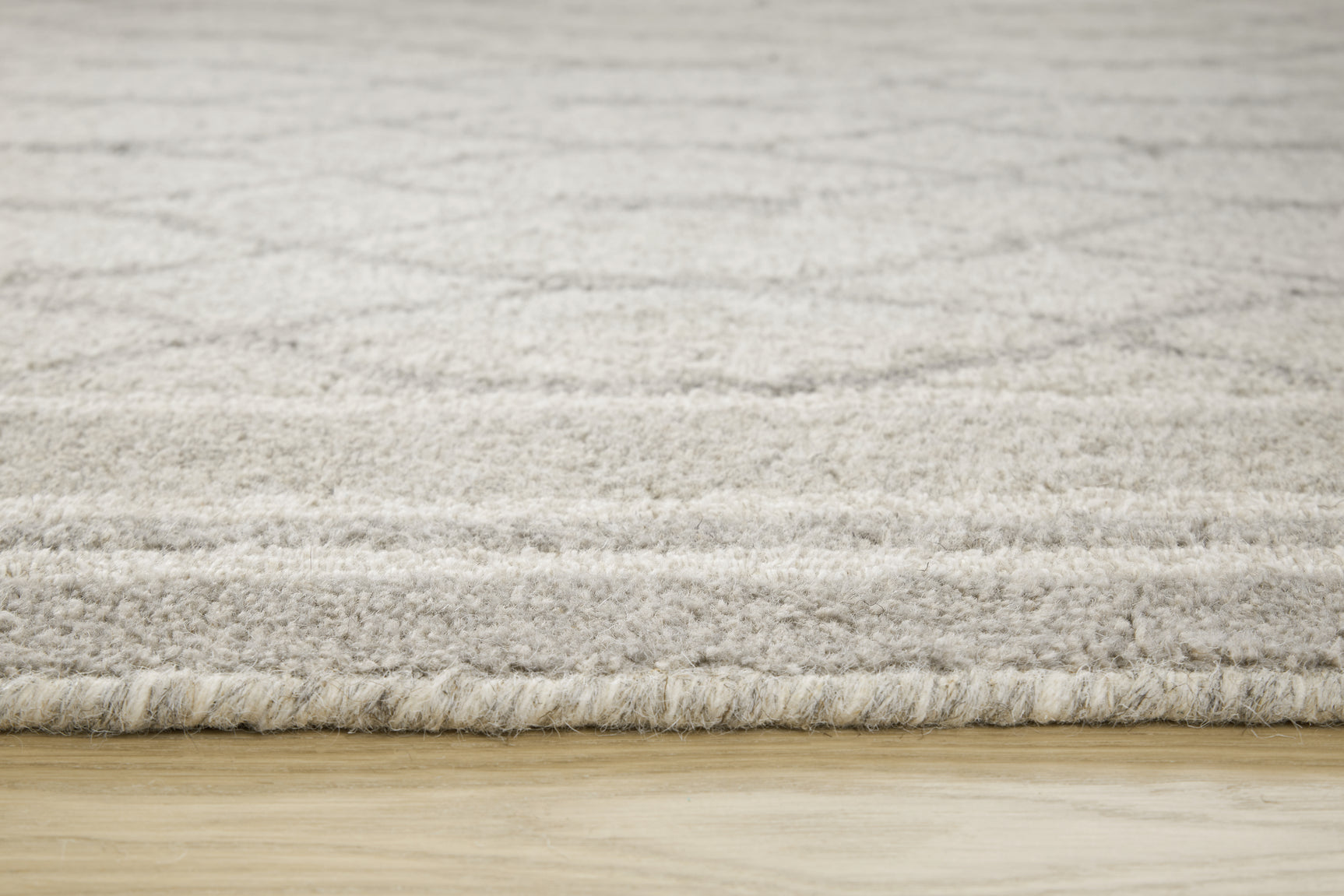 Rolled Wimney gray wool rug edge detail