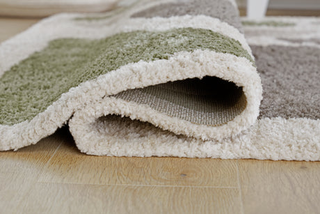 Rolled edge detail of Anburgh green gray ivory rug