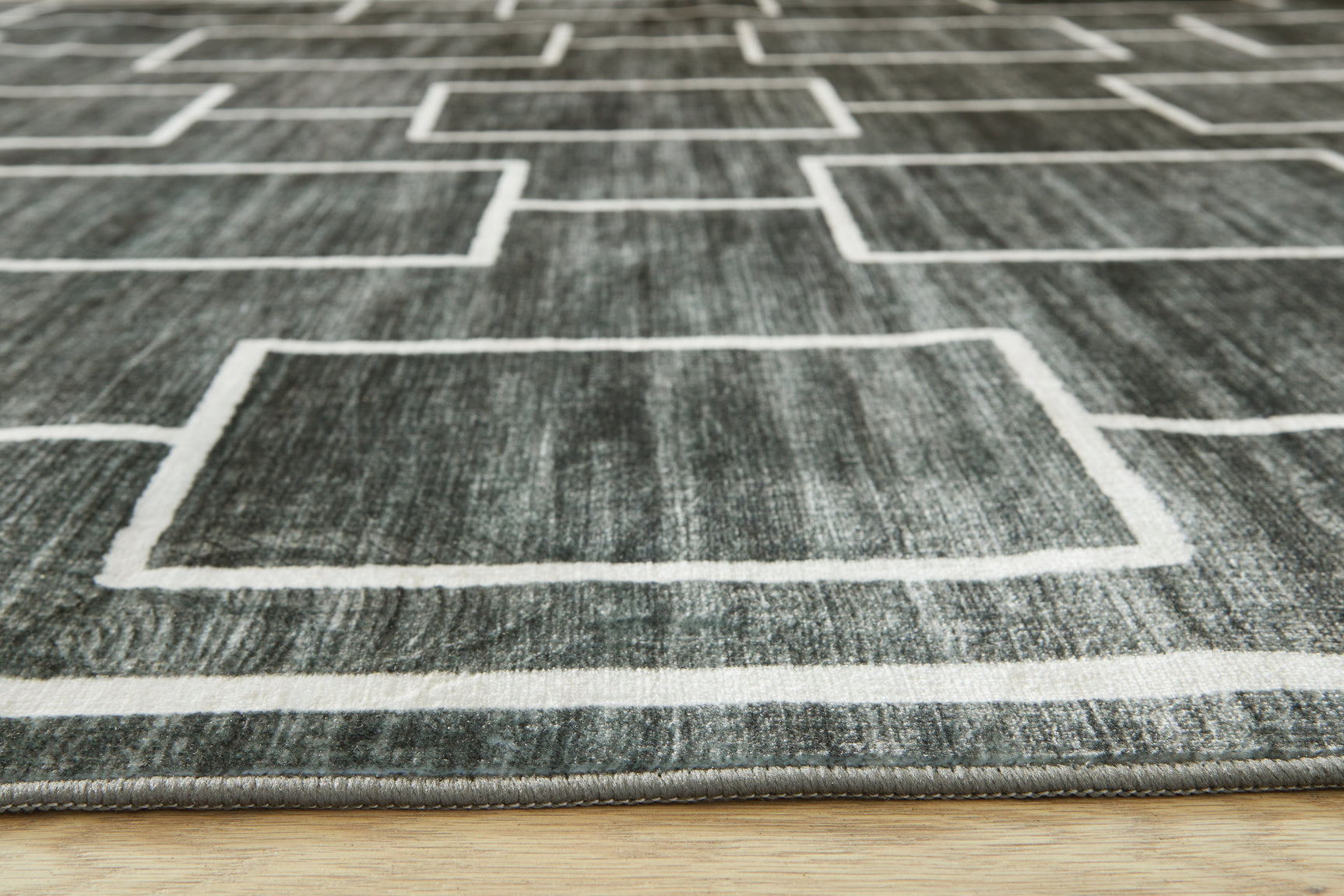 Roll of Elderland black gray area rug fabric closeup