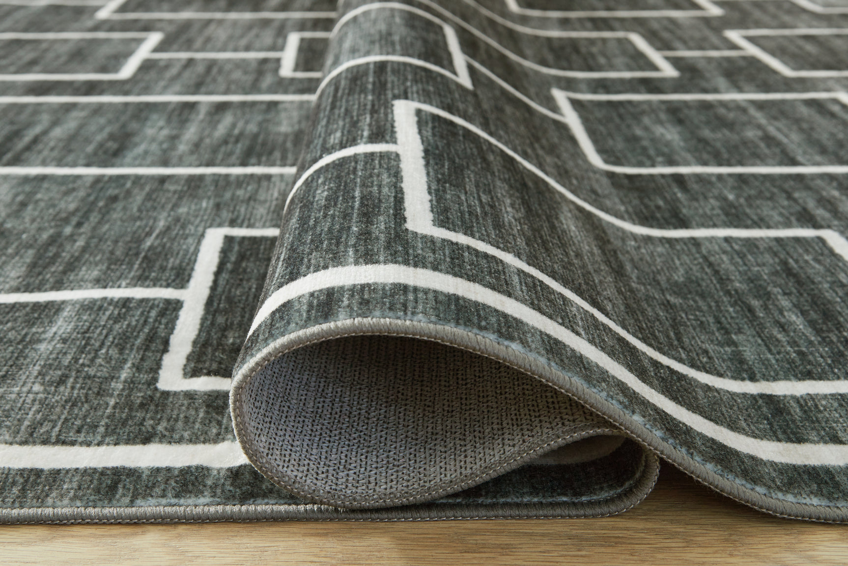 Rolled Elderland rug showing backing texture