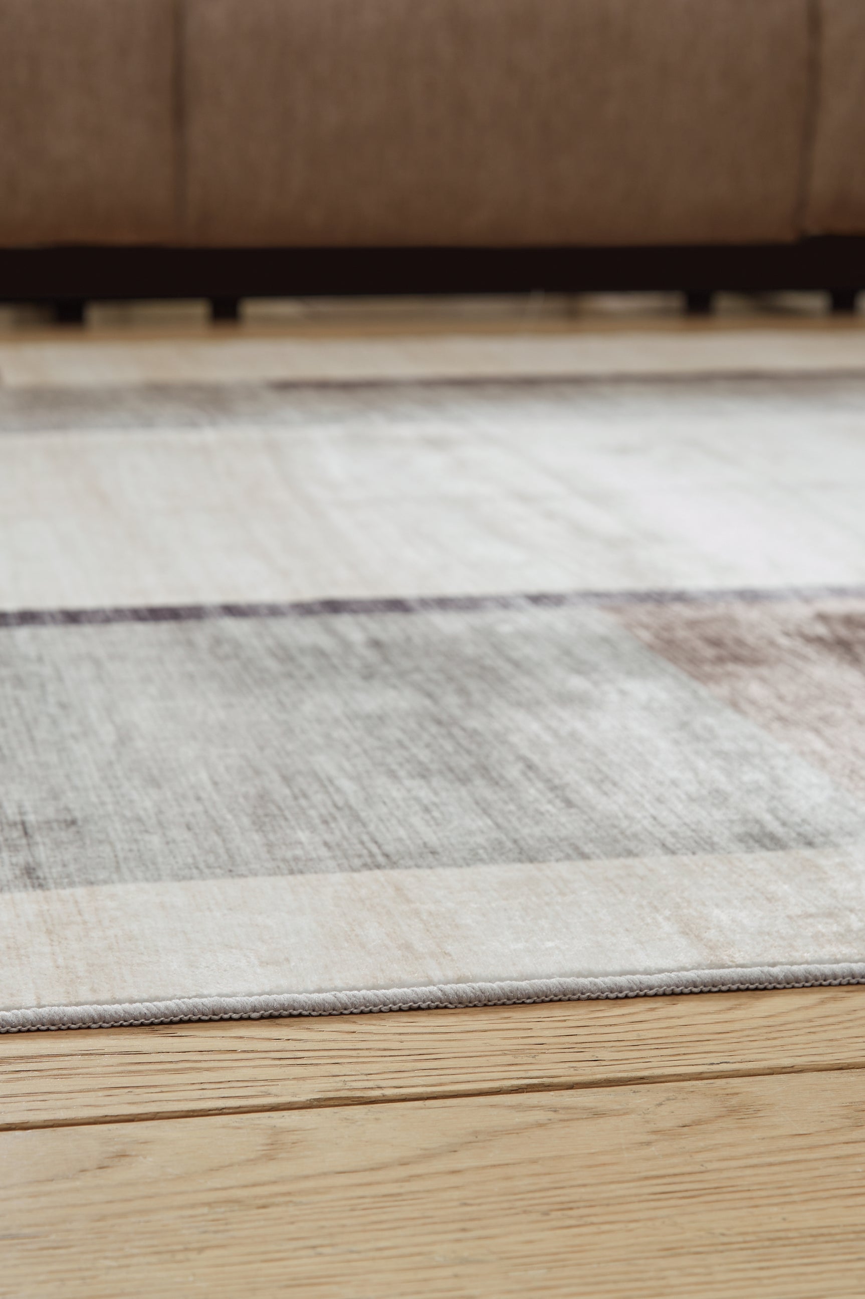 Rolled view showing back of Larkport washable area rug