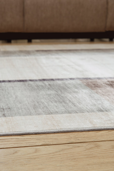 Rolled view showing back of Larkport washable area rug