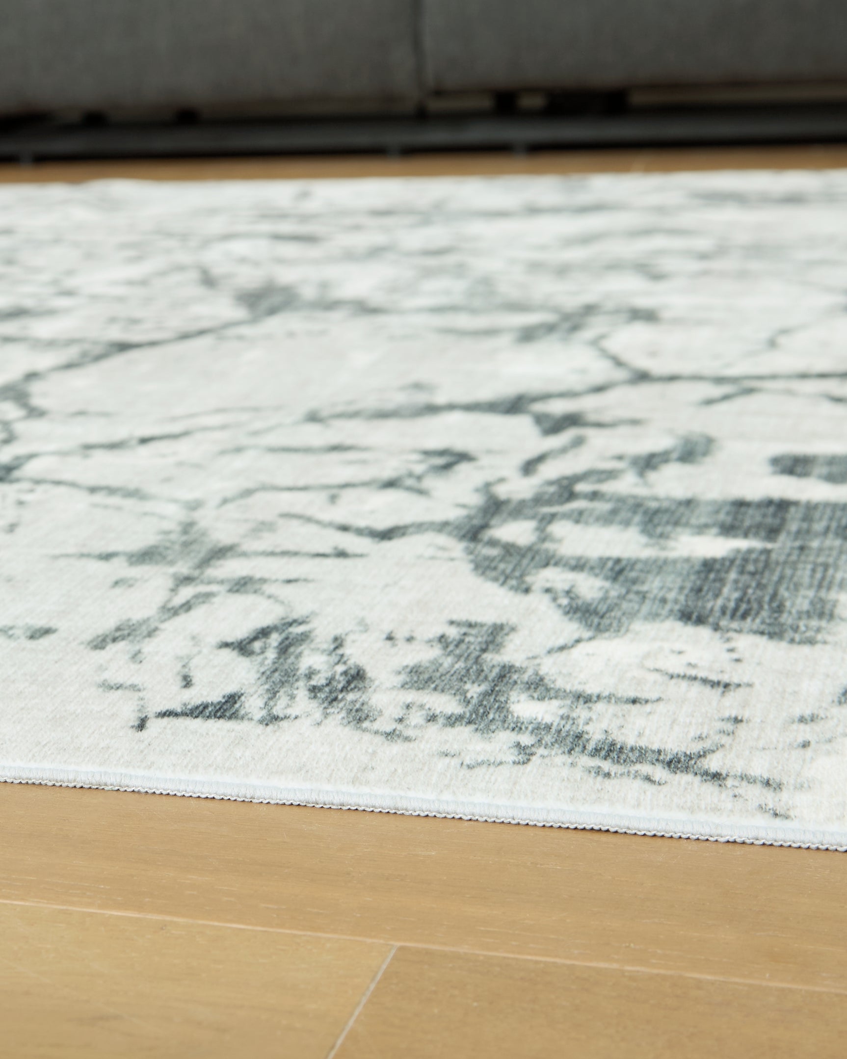 Rolled Tobinbury Gray Washable Area Rug side view