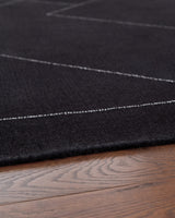 Detail of hand-tufted wool pattern in black and white