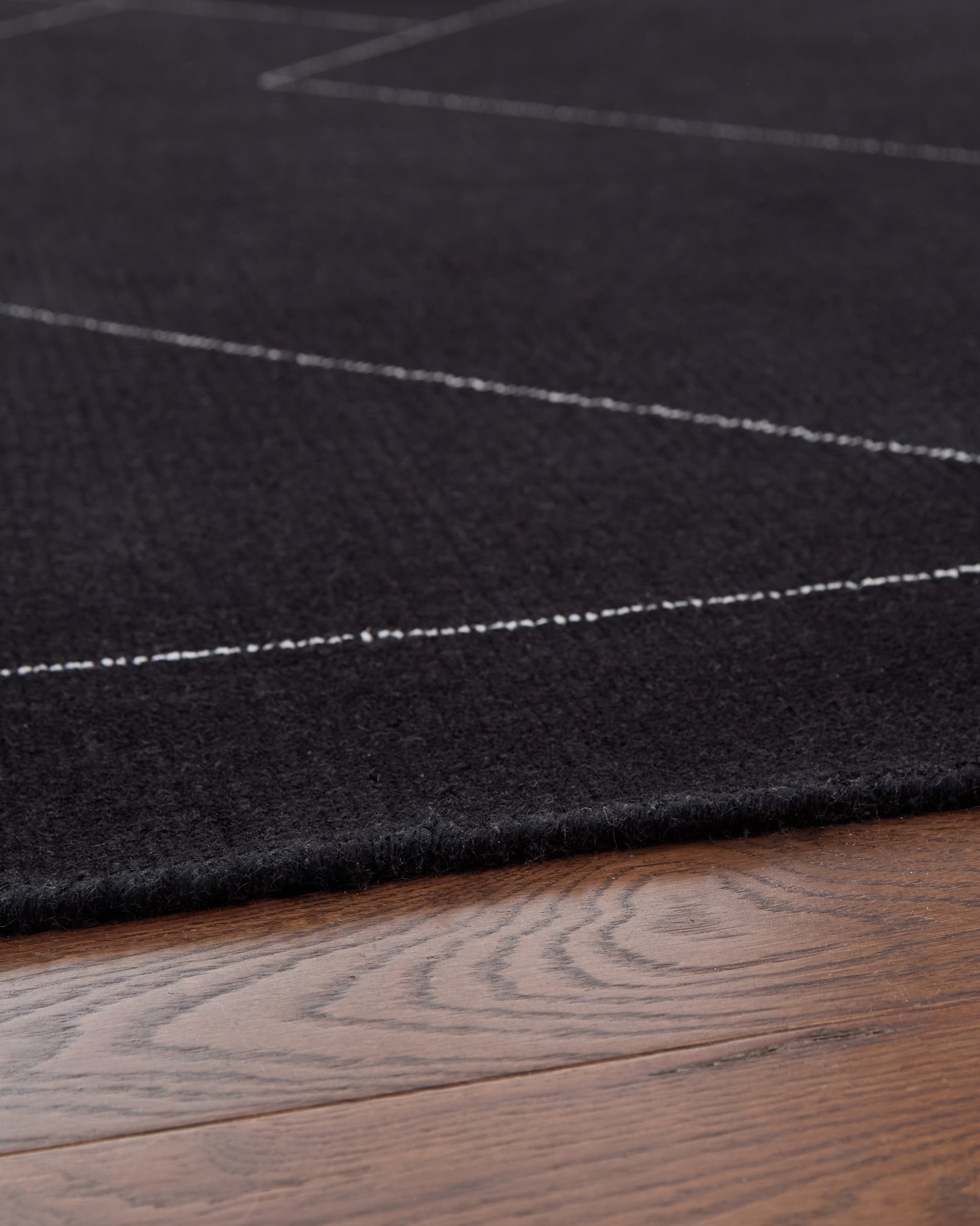 Detail of hand-tufted wool pattern in black and white