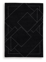 Close-up of Marav rug's hand tufted wool texture with black and white pattern