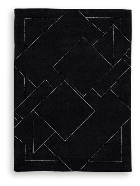 Close-up of Marav rug's hand tufted wool texture with black and white pattern