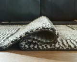 Kurtmen rug rolled showing backside jute material