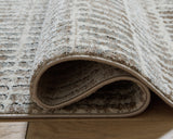 Rolled Fuadwick area rug showing backing and edge