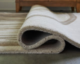 Rolled Rizwana rug showing wool texture detail
