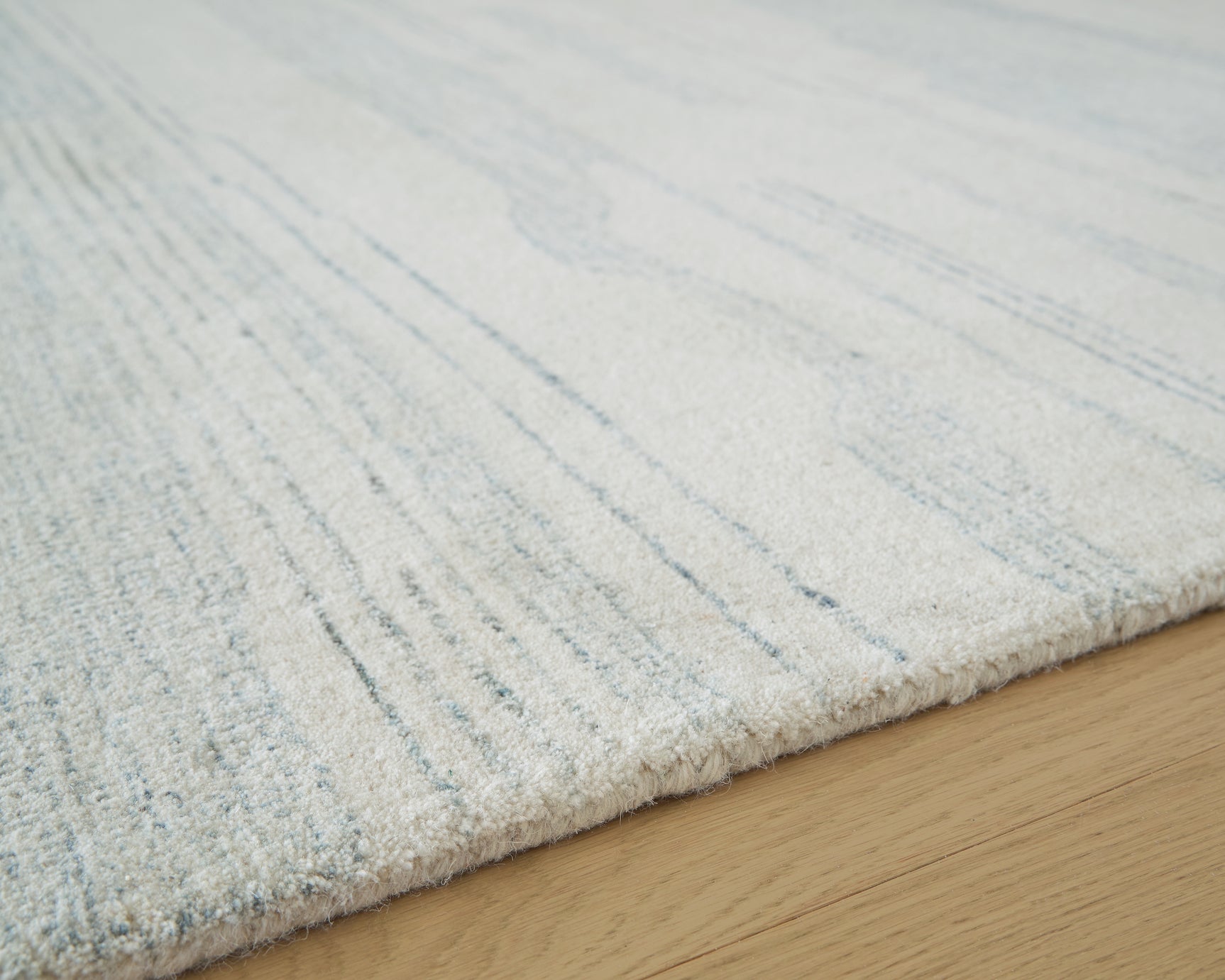 Hand-tufted fiber texture detail of Genemost rug