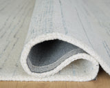 Rolled edge detail of Genemost ivory and blue rug