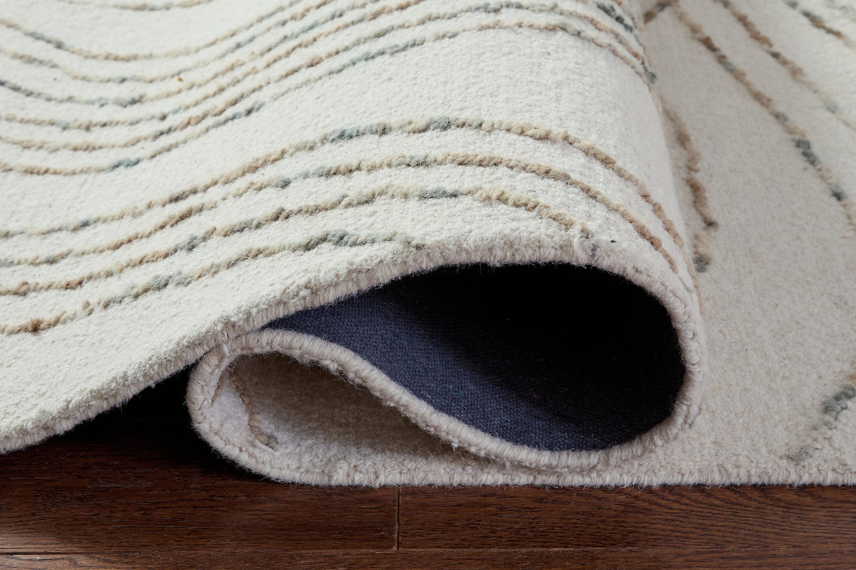 Rolled Deenbury 5x7 wool area rug side view