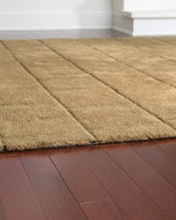 Rolled Luzmont golden brown wool rug edge detail