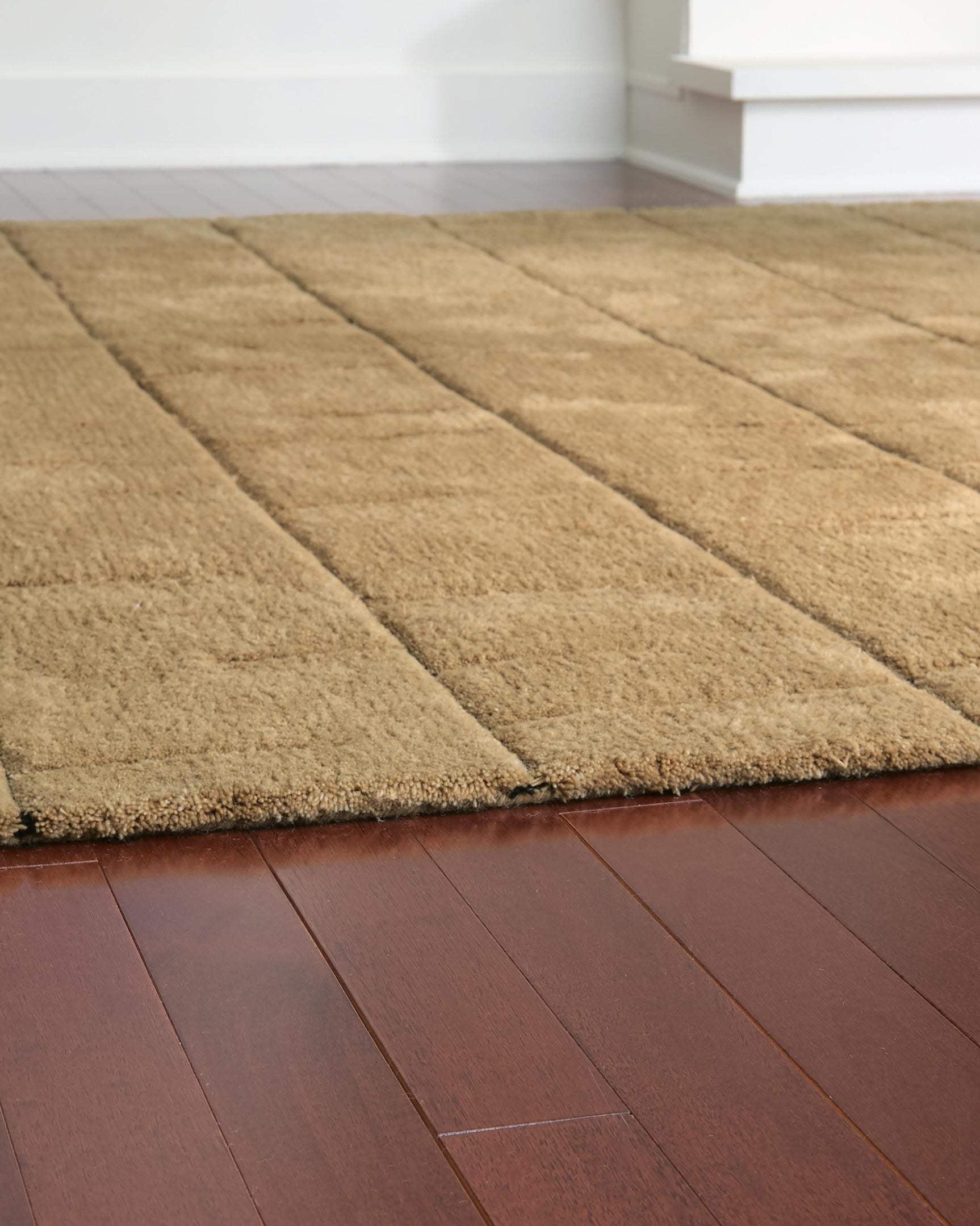 Rolled Luzmont golden brown wool rug edge detail