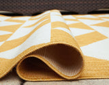 Rolled detail of Thomley Ivory Yellow area rug