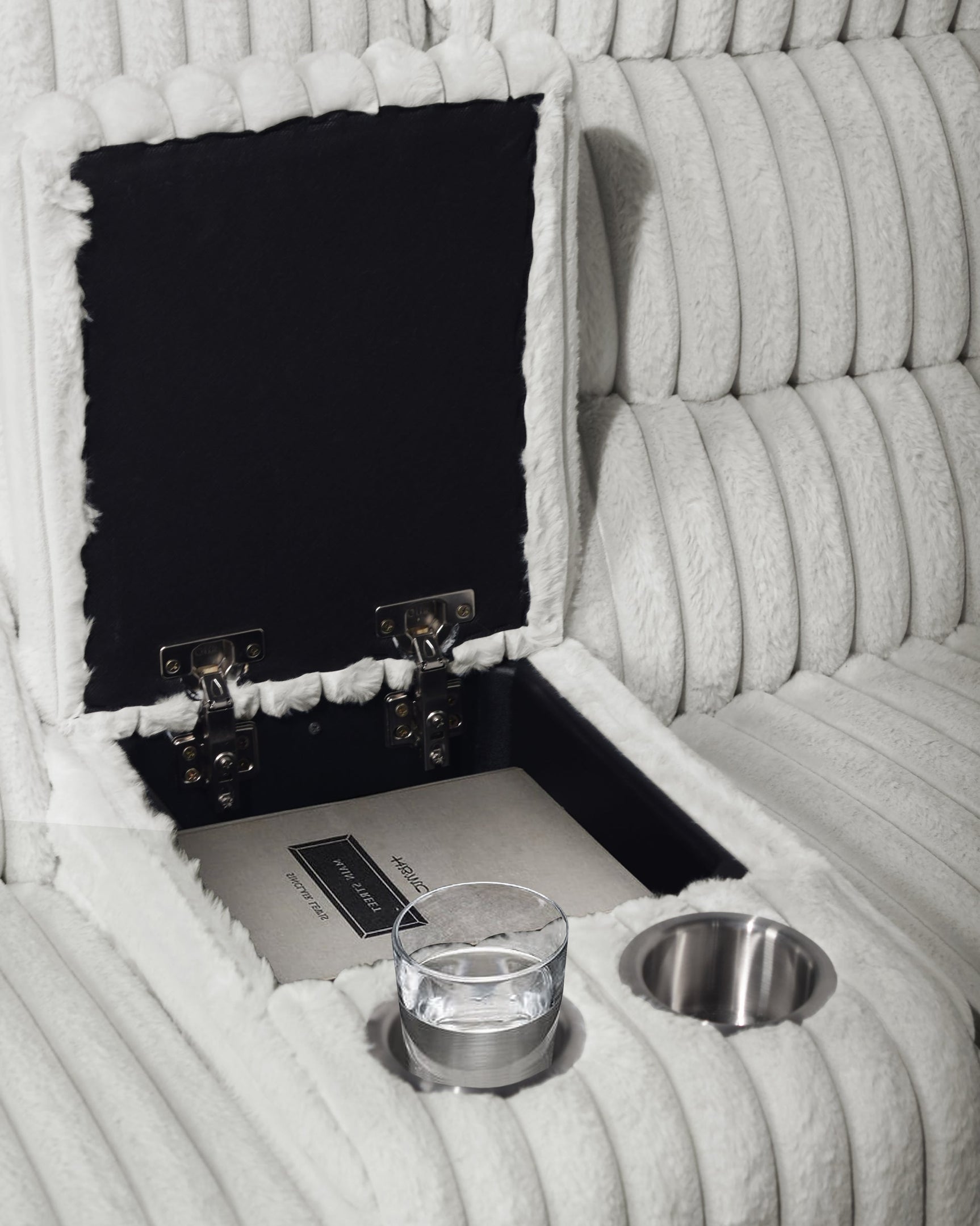 Close-up of console storage and stainless steel cupholders
