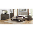 Close-up of tufted headboard on gray queen panel bed