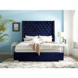 Closeup of tufted blue velvet upholstery on headboard