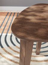 Lyncott Medium Brown Wood Table Set displayed with decor