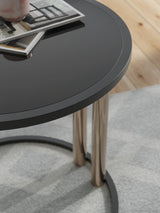 Detail of Hannerly end table with black glass top and metal legs