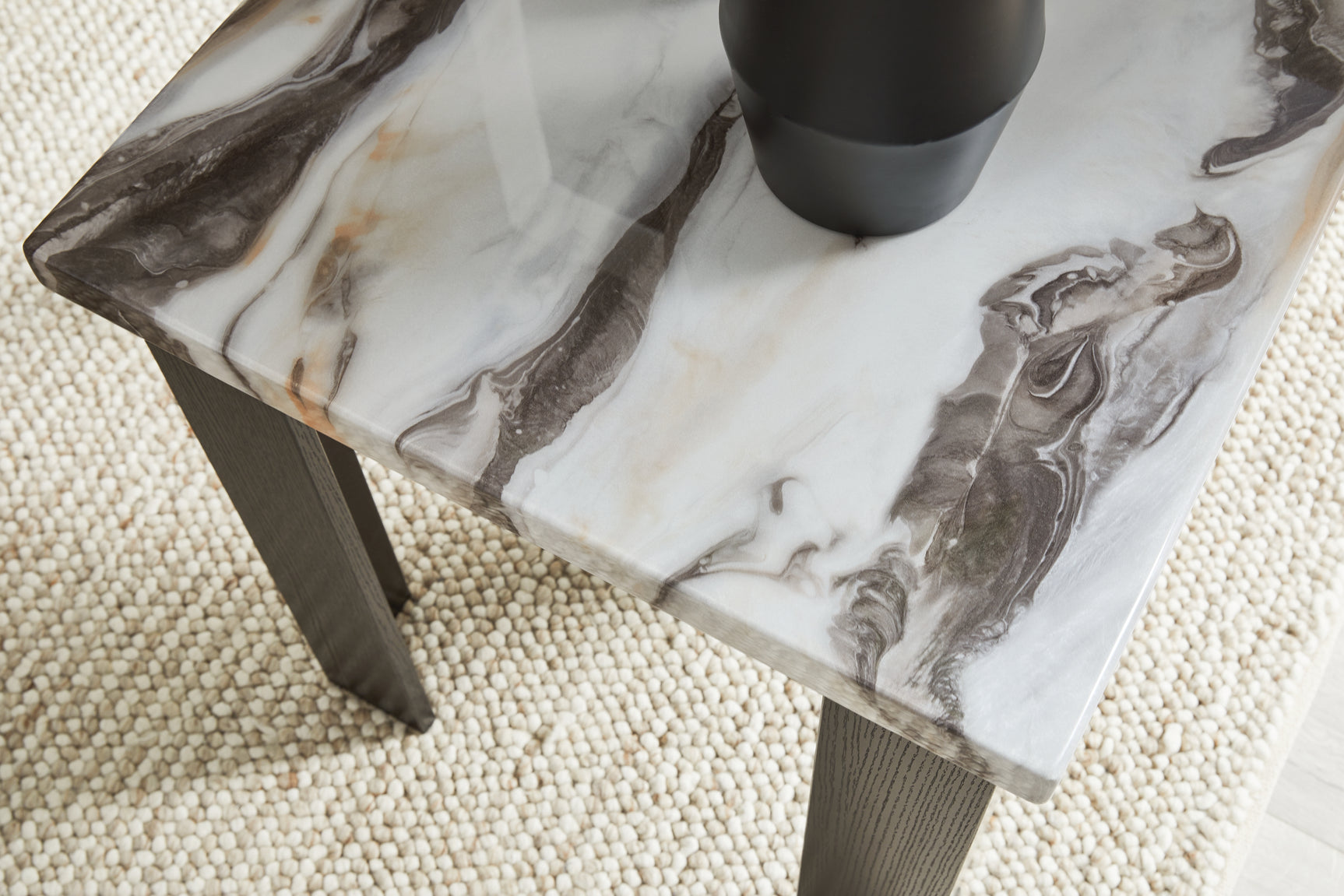 Close-up view of end table corner with marble top