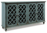 Side angle of Mirimyn Antique Teal Accent Cabinet highlighting distressed finish