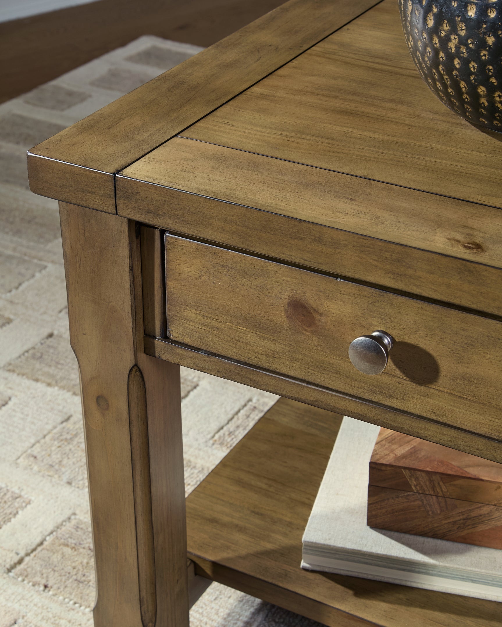 Close-up detail of dark bronze-tone knob on Vandenmore end table