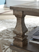 Johnelle Gray rectangular coffee table with weathered finish from front angle